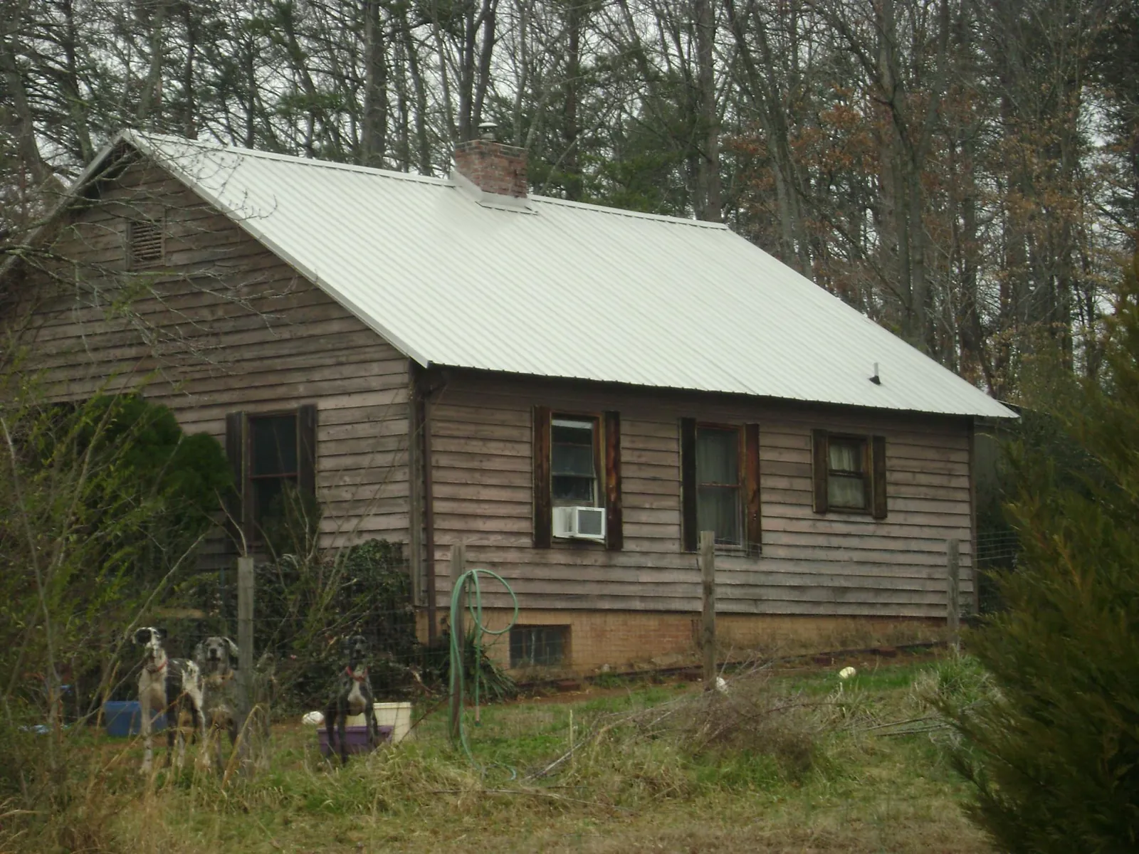White metal roof on an old wood sided farmhouse, from a Metal Roof Installation job in Honeoye